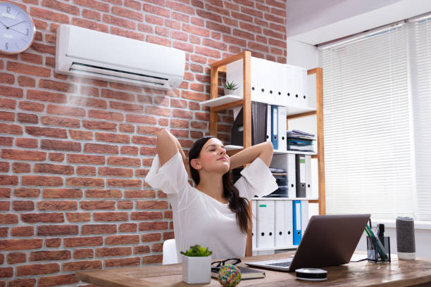 Relaxed Businesswoman Enjoying The Cooling Of Air Conditioner In The Office